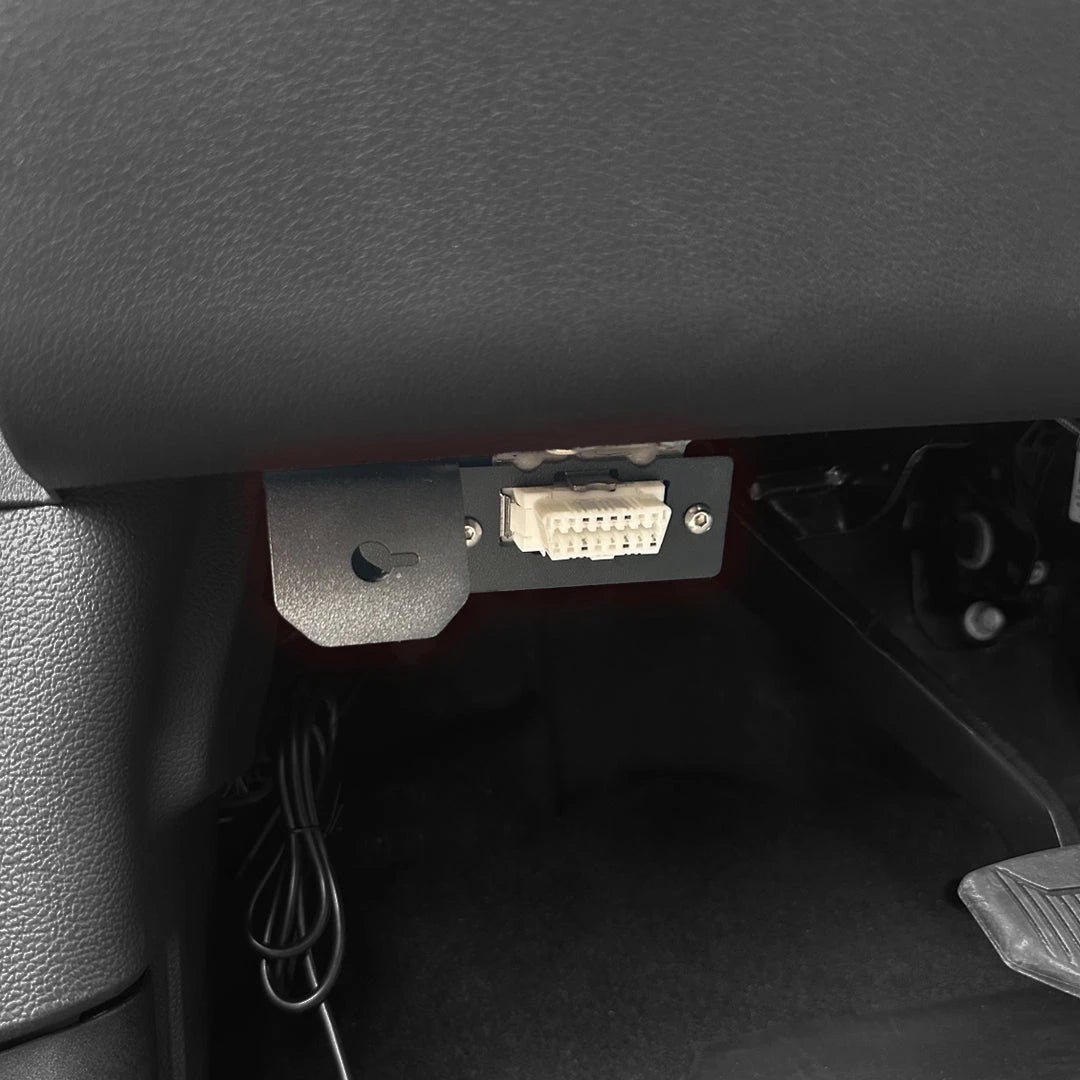GDP Rotary Switch Bracket installed under the dash of a 2023-2026 6.7L Ford Powerstroke with the OBDII port relocated into the bracket